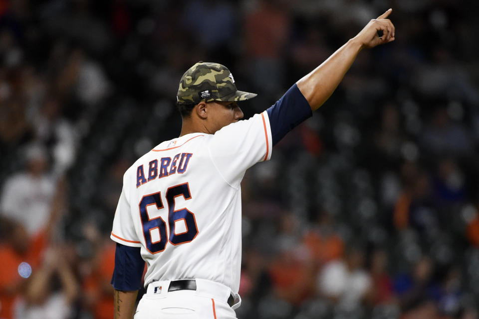 Houston Astros relief pitcher Bryan Abreu points to right fielder Myles Straw after Straw caught a fly ball by Texas Rangers' David Dahl during the sixth inning of a baseball game, Saturday, May 15, 2021, in Houston. (AP Photo/Eric Christian Smith)