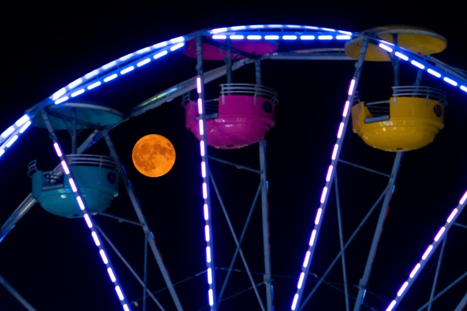Aug 1, 2023; Columbus, Ohio, USA;  The sturgeon moon, the first of two supermoons in August, rises over the Ohio State Fair. According to the Farmer’s Almanac, August’s full moon is called the sturgeon moon because the giant sturgeon fish that could be readily caught in the Great Lakes this time of year. The next full blue moon will occur on Aug. 30. 
