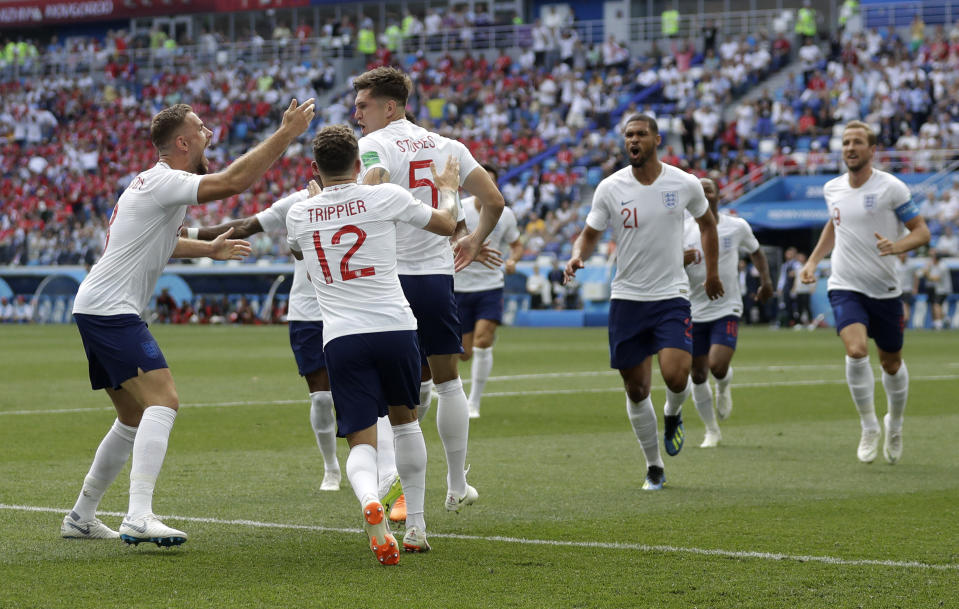 <p>England players run to teammate John Stones after he scored his team’s first goal </p>