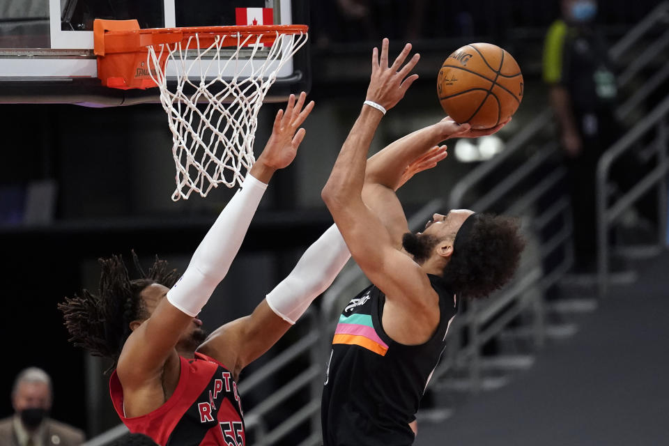 San Antonio Spurs guard Derrick White (4) puts up a shot over Toronto Raptors forward Freddie Gillespie (55) during the first half of an NBA basketball game Wednesday, April 14, 2021, in Tampa, Fla. (AP Photo/Chris O'Meara)