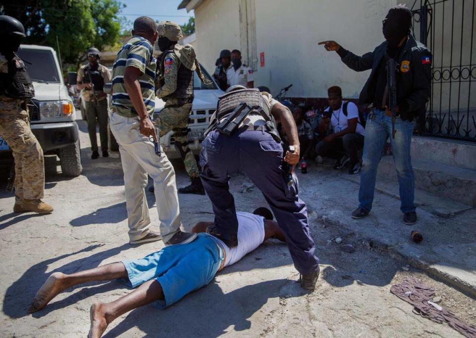An inmate is recaptured outside the Croix-des-Bouquets Civil Prison after an attempted breakout, in Port-au-Prince, Haiti, Thursday, Feb. 25, 2021. At least eight people were killed and one injured on Thursday after eyewitnesses told The Associated Press that several inmates tried to escape from a prison in Haiti’s capital. 