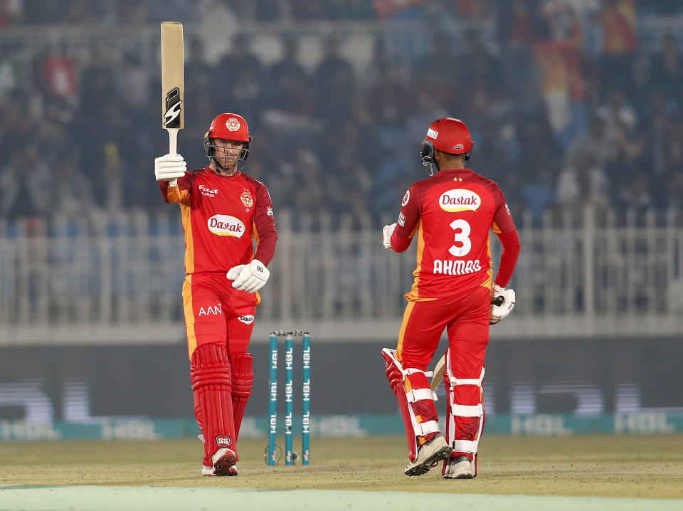 Islamabad United batsman Colin Ingram, left, celebrates after completing his fifty during the Pakistan Super League T20 cricket match against Quetta Gladiators at Rawalpindi stadium in Rawalpindi, Pakistan, Thursday, Feb. 27, 2020. (AP Photo/Anjum Naveed)