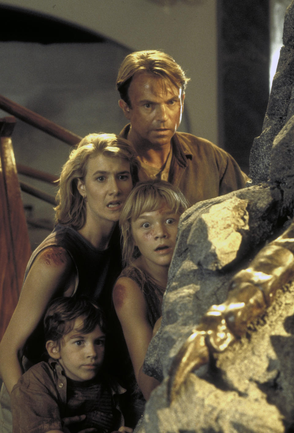 Actor Sam Neill as Dr. Alan Grant and actress Laura Dern as Dr. Ellie Sattler, with Ariana Richards (right) and Joseph Mazzello (left) as Lex and Tim, in a scene from the film 'Jurassic Park', 1993.  (Photo by Murray Close/Getty Images)
