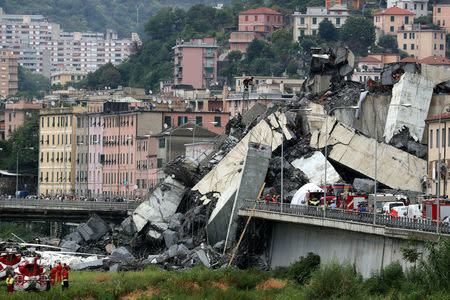 The collapsed Morandi Bridge is seen in the Italian port city of Genoa, Italy August 14, 2018. REUTERS/Stefano Rellandini