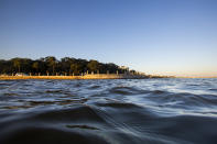 As high tide laps against the sea wall tourist walk down the Battery in Charleston, S.C. Friday, Nov. 13, 2020. Charleston has remained relatively unscathed this hurricane season. That means more time to mull a $1.75 billion proposal by the Army Corps of Engineers that features a sea wall along the city's peninsula to protect it from deadly storm surge during hurricanes. (AP Photo/Mic Smith)