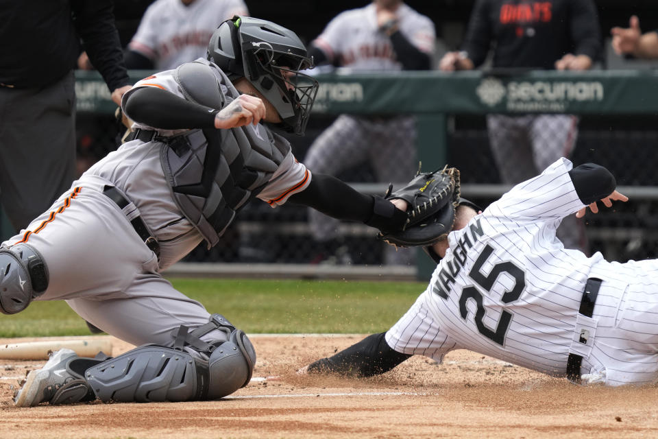 San Francisco Giants catcher Roberto Perez, left, tags out Chicago White Sox's Andrew Vaughn at home during the first inning of a baseball game in Chicago, Wednesday, April 5, 2023. (AP Photo/Nam Y. Huh)