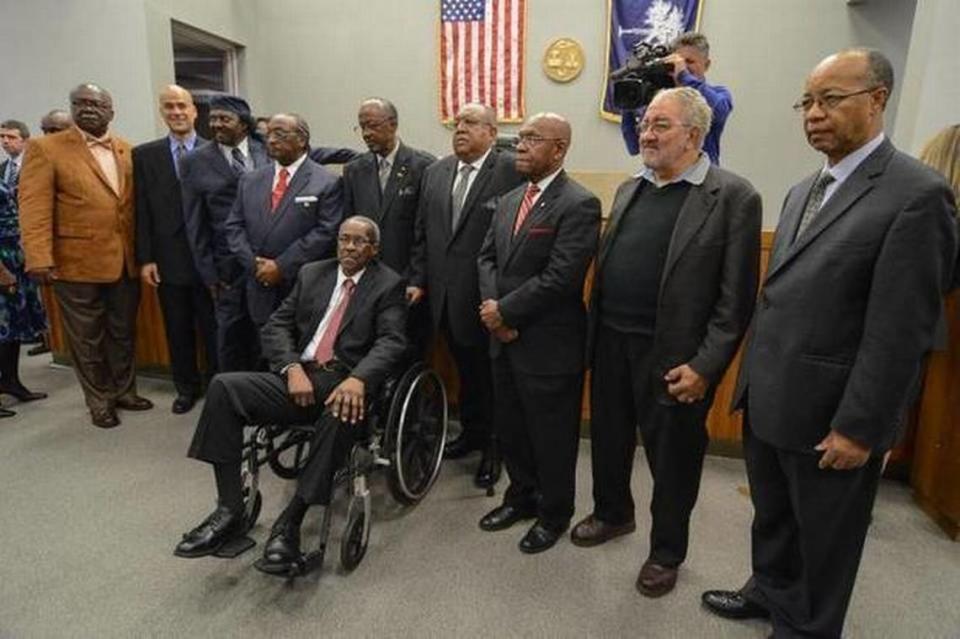 The surviving members of the Friendship Nine and other civil rights protesters whose 1961 convictions for trespassing were vacated in January by a judge. From left, David Williamson, Kenn Gaither (standing in for his father, Thomas Gaither), Mack Workman, Willie McCleod, John Gaines, Clarence Graham, W.T. Massey, Charles Jones, Charles Sherrod and James Wells (seated).