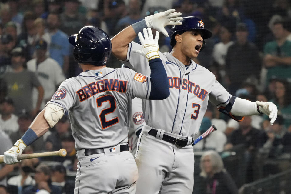 Houston Astros' Jeremy Pena (3) celebrates a home run against the Seattle Mariners with Alex Bregman (2) during the 18th inning in Game 3 of an American League Division Series baseball game Saturday, Oct. 15, 2022, in Seattle. (AP Photo/Ted S. Warren)