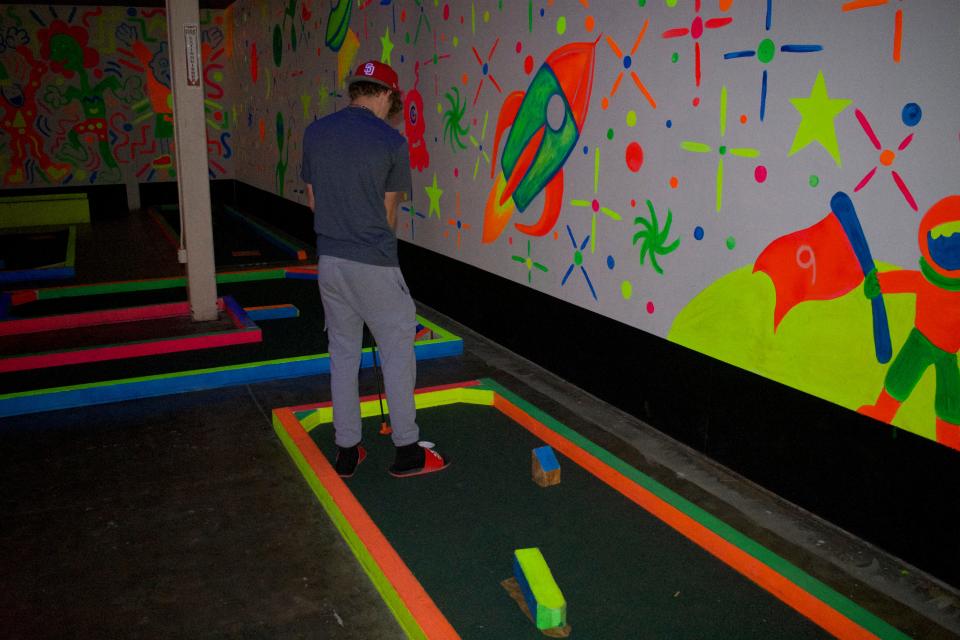 APS High School student plays mini golf on the last day of the Healing Hearts Grief camp on Friday, June 23 at Pizza 9