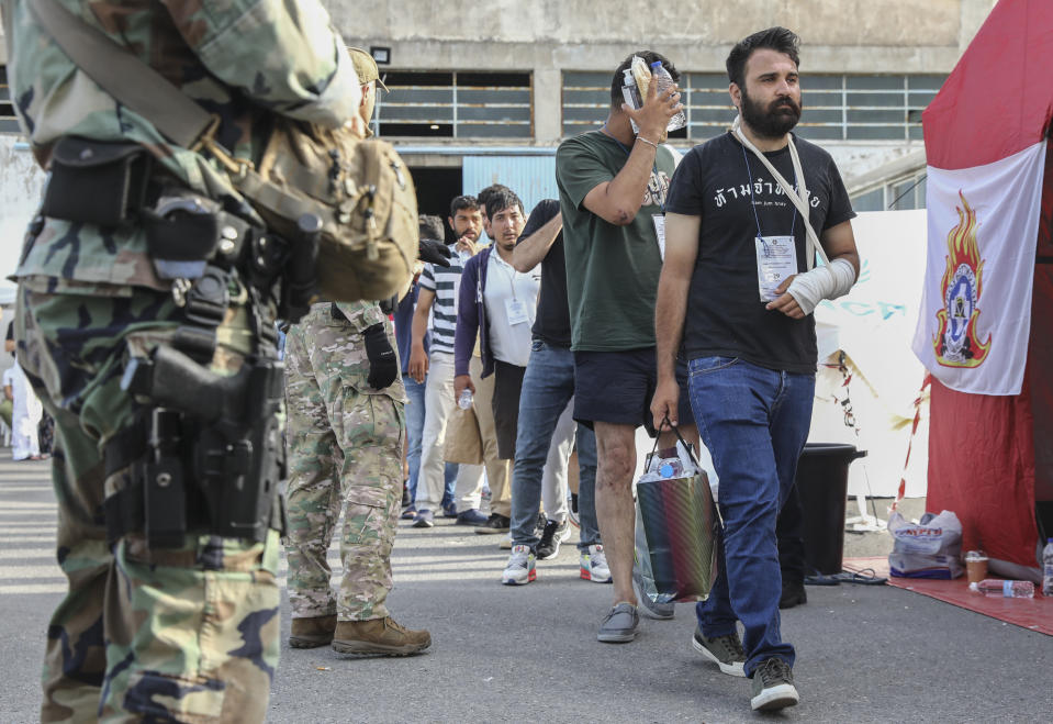 Survivors of latest tragical shipwreck prepare to board a bus to transfer to Athens at the port of Kalamata, Greece, Friday, June 16, 2023. The round-the-clock effort continued off the coast of southern Greece despite little hope of finding survivors or bodies after none have been found since Wednesday, when 78 bodies were recovered and 104 people were rescued. (John Liakos/InTime News via AP)