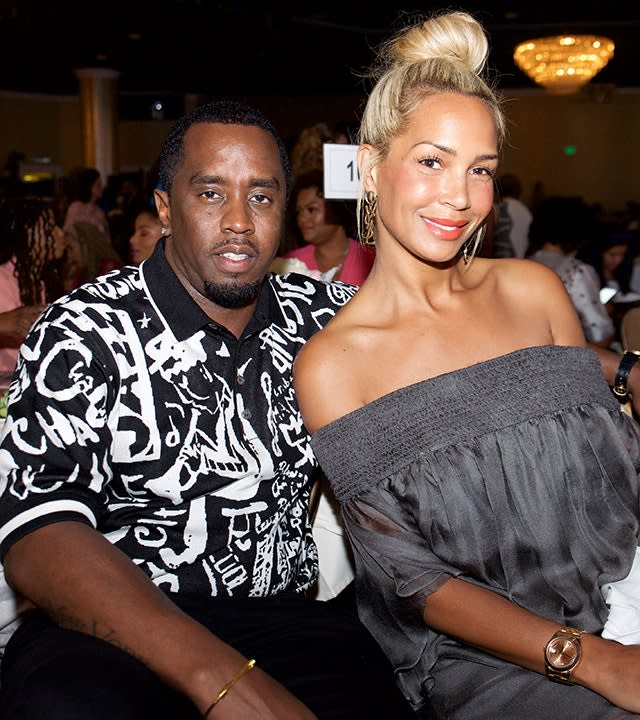 Sean Combs in a black and white printed shirt sits next to Sarah Chapman in a grey off the shoulder top