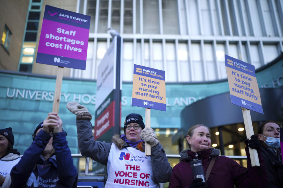 Members of the Royal College of Nursing (RCN) protest as nurses in England, Wales and Northern Ireland take industrial action over pay, outside the Bristol Royal Infirmary, England, Tuesday, Dec. 20, 2022. (Ben Birchall/PA via AP)
