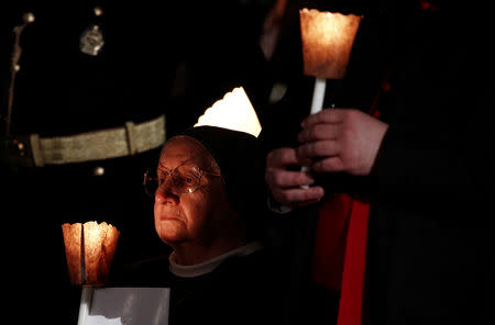 A nun attends the Via Crucis (Way of the Cross) procession led by Pope Francis during Good Friday celebrations at Rome's Colosseum, Rome, Italy April 19, 2019. REUTERS/Yara Nardi