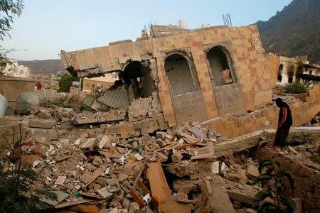 A man stands on the rubble of a house destroyed during recent battles between Houthi fighters and pro-government fighters, on the first day of a 48-hour ceasefire in the southwestern city of Taiz, Yemen. REUTERS/Anees Mahyoub