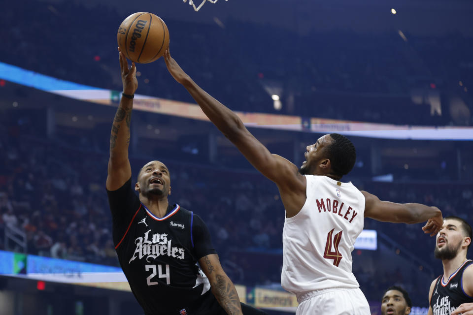 Cleveland Cavaliers forward Evan Mobley (4) blocks a shot by Los Angeles Clippers forward Norman Powell (24) during the first half of an NBA basketball game, Sunday, Jan. 29, 2023, in Cleveland. (AP Photo/Ron Schwane)