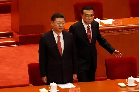 China's President Xi Jinping and Premier Li Keqiang arrive for the ceremony to mark the 90th anniversary of the founding of the China's People's Liberation Army at the Great Hall of the People in Beijing, China August 1, 2017. REUTERS/Damir Sagolj