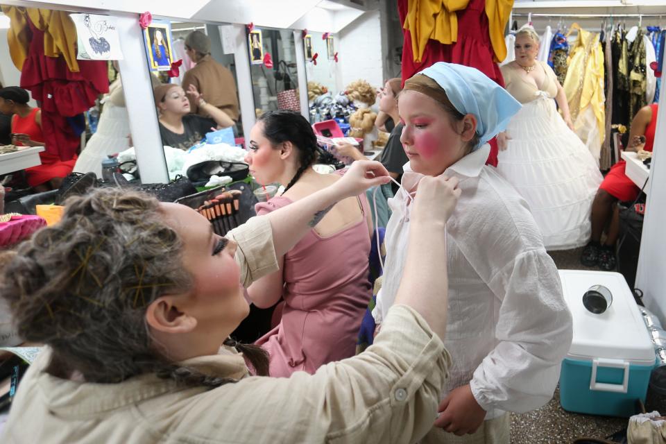 Aubrey Smith, left, helps Ava Bartlett get into her Chip costume for Springfield Little Theatre's premiere of "Beauty and the Beast" at The Landers Theatre on Thursday, June 8, 2023. The production closes out Springfield Little Theatre's 88th season and will run June 9-25, 2023.