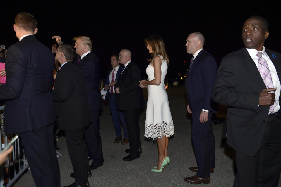 First lady Melania Trump, center, watches as President Donald Trump greets the crowd after they arrived at Palm Beach International Airport in West Palm Beach, Fla., Tuesday, Nov. 20, 2018. The Trumps are spending the Thanksgiving Day week at their Mar-a-Lago estate in Palm Beach. (AP Photo/Susan Walsh)