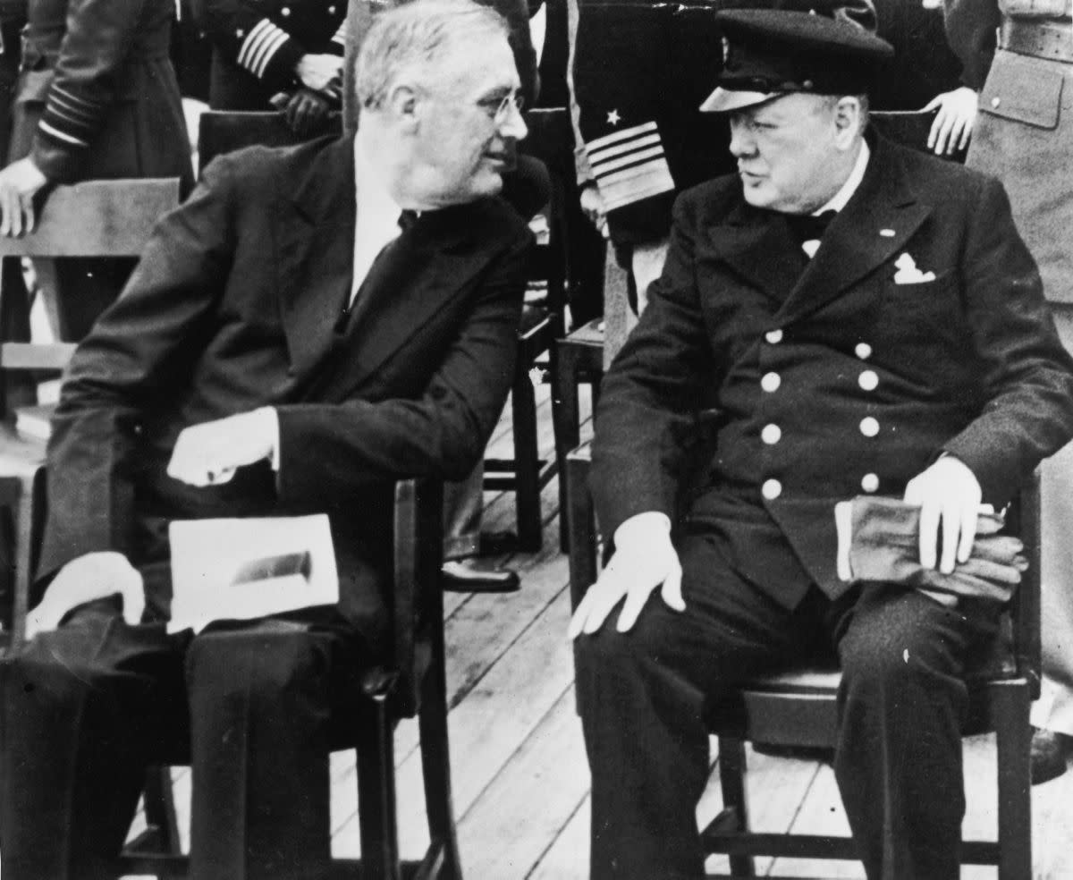 During his first term as Prime Minister, Winston Churchill established a strong relationship with former U.S. President Franklin Delano Roosevelt. He exchanged more than a thousand letters and telegrams and met 11 times. Here, they meet on board the HMS Prince of Wales in Newfoundland to discuss the Atlantic Charter. They worked together to create the Lend-Lease Act, in which the U.S. would supply Britain with vital food and oil in return for defending the U.S.