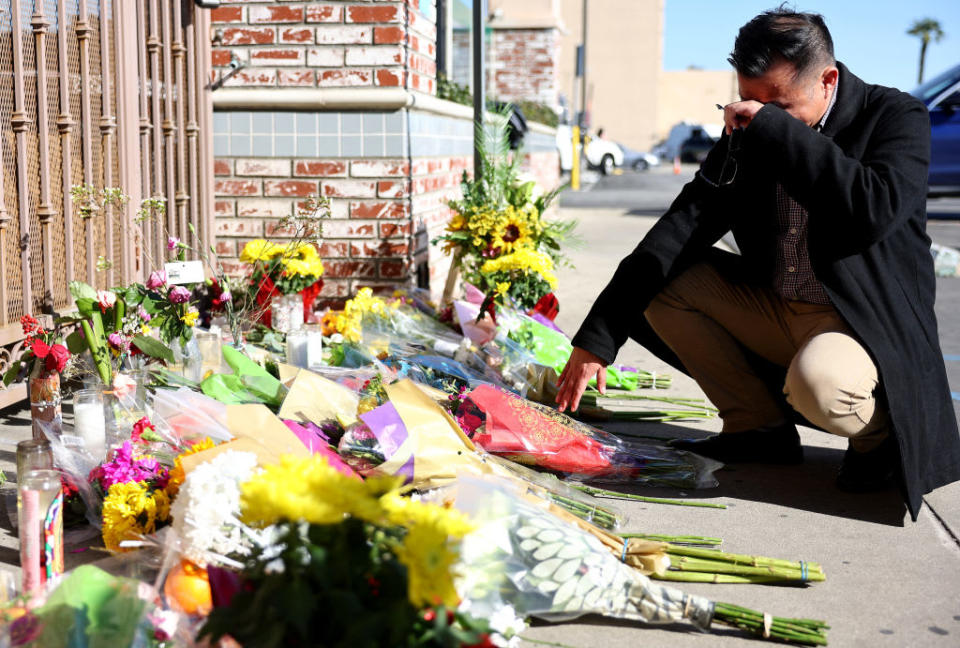 <div class="inline-image__caption"><p>Monterey Park mayor Henry Lo kneels at a makeshift memorial outside the scene of the shooting on Monday in Monterey Park, California. </p></div> <div class="inline-image__credit">Mario Tama/Getty Images</div>