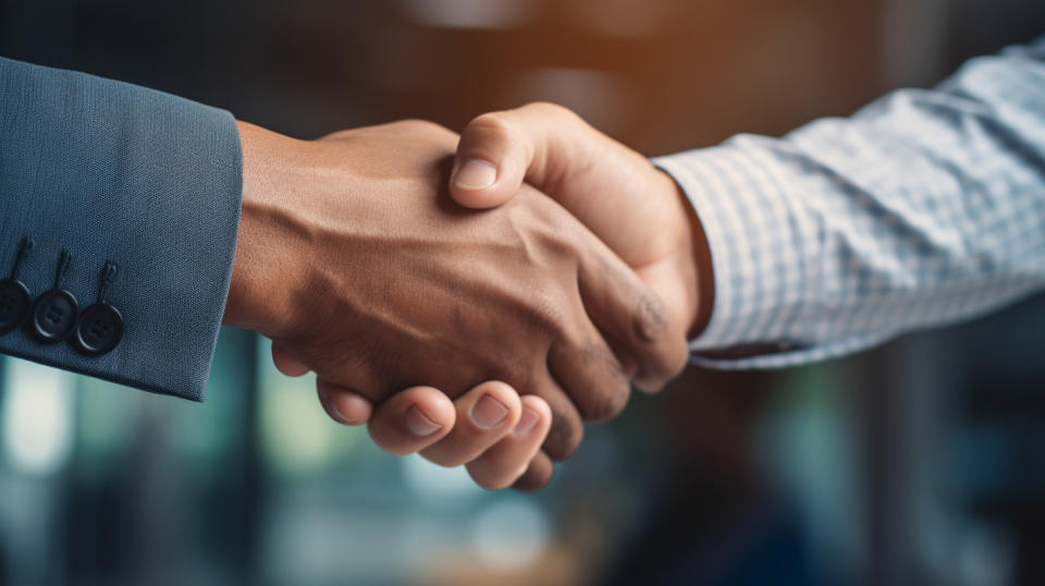 Close up of a handshake between two individuals, showing the trust and reliability of life insurance.