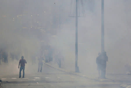 Palestinian protesters stand amidst tear gas fired by Israeli troops during clashes following a protest in solidarity with Palestinian prisoners held by Israel, in the West Bank town of Bethlehem April 17, 2017. REUTERS/Ammar Awad