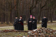 Jewish and Christian clerics pray at the former crematorium during a ceremony in the former Nazi German concentration and extermination camp Auschwitz during ceremonies marking the 78th anniversary of the liberation of the camp in Brzezinka, Poland, Friday, Jan. 27, 2023. (AP Photo/Michal Dyjuk)