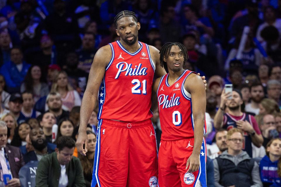 Philadelphia 76ers center Joel Embiid (21) and guard Tyrese Maxey (0) stand together during a break in action in the fourth quarter against the Orlando Magic at Wells Fargo Center on April 12, 2024.