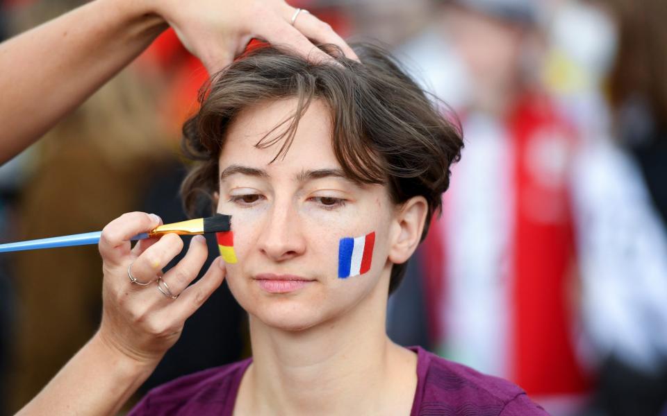 Fan wears the flags of Germany and France as face paint at the Fan Festival - Getty Images