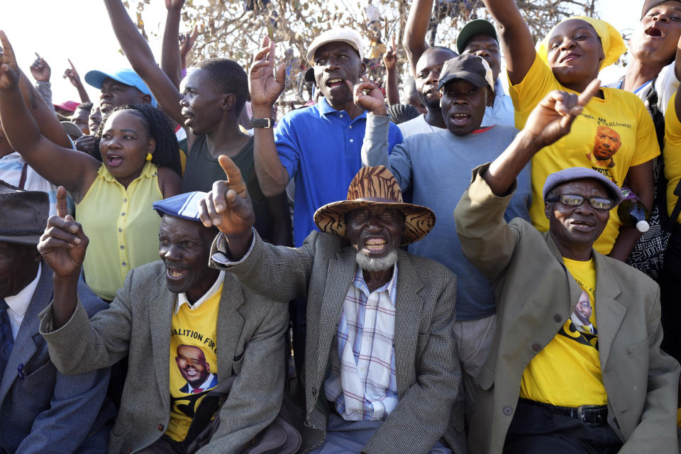 Opposition party supporters attend a campaign rally in Zimbabwe's rural Domboshava area, Tuesday, Aug. 15 2023. People in Zimbabwe's rural areas claim they are facing intimidation and a biased state-run media which limits their ability to support opposition parties ahead of national elections next week. To combat that, one group of grandmothers is using the WhatsApp messaging app to spread information from the opposition party they support in an attempt to cut through the propaganda. (AP Photo/Tsvangirayi Mukwazhi)