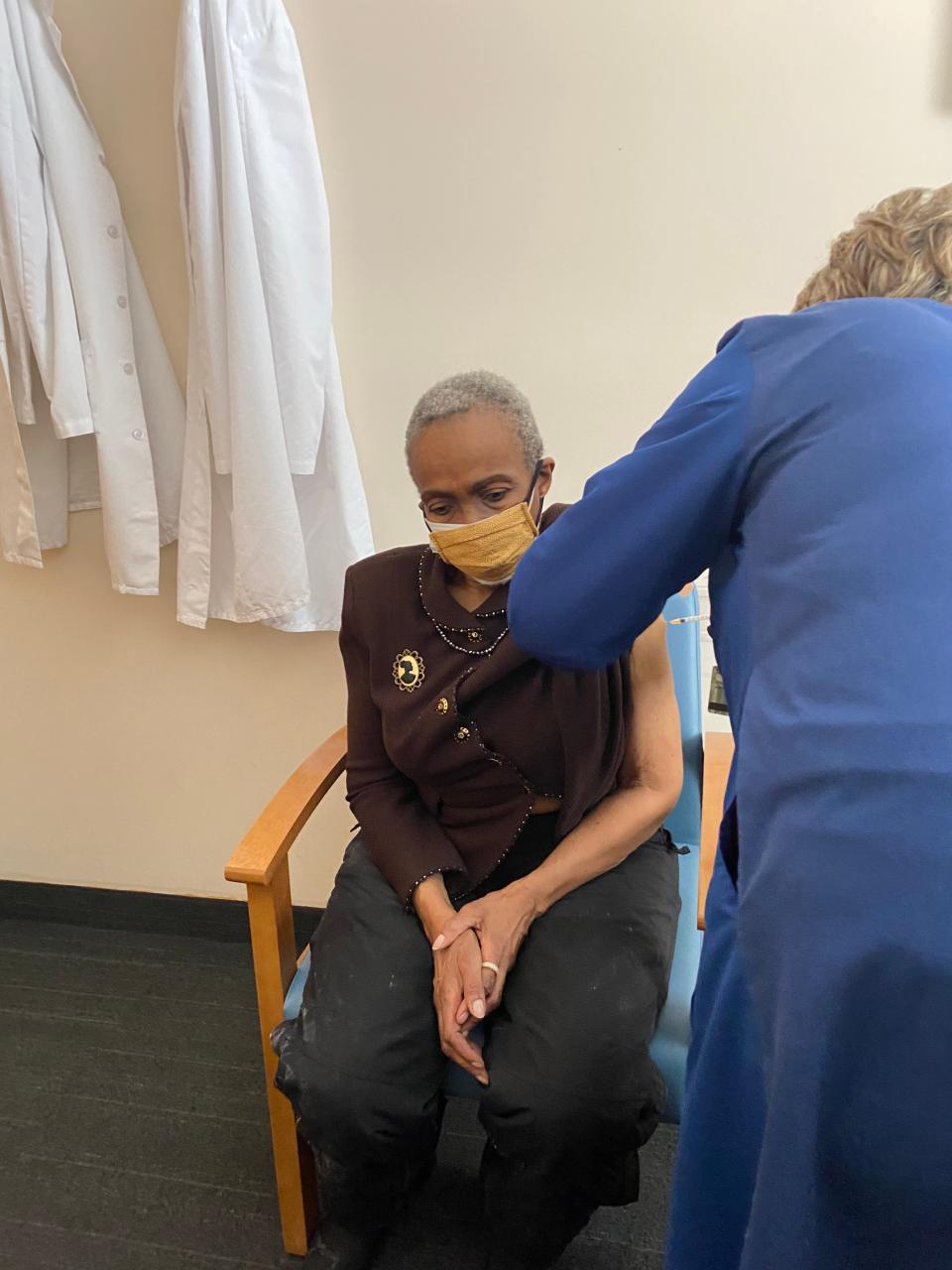 Jewelean Jackson, a patient, community health worker and former governing board chair at  Minnesota's Community-University Health Care Center, receives her first dose of the Moderna COVID-19 vaccine.