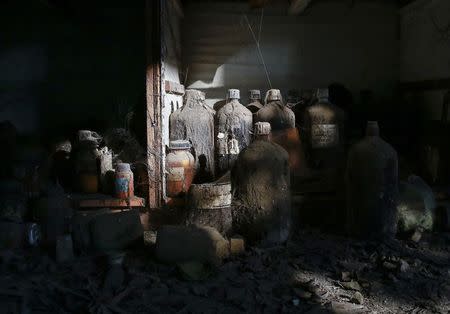 Thick dust covers chemical bottles in a laboratory at the abandoned former Union Carbide pesticide plant in Bhopal November 14, 2014. REUTERS/Danish Siddiqui