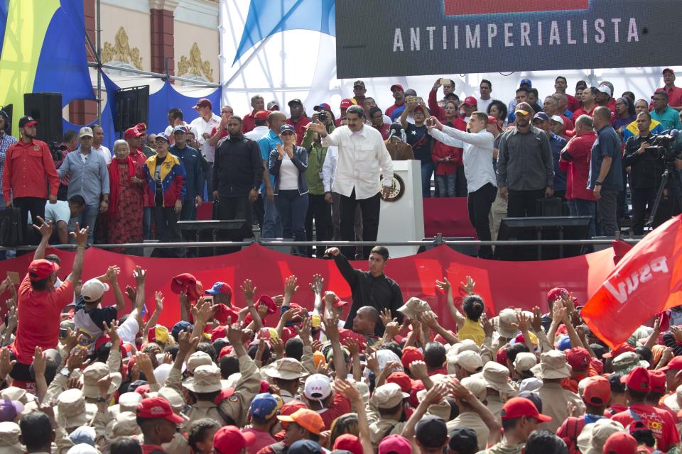 Venezuela's President Nicolas Maduro acknowledges supporters during a government rally in Caracas, Venezuela, Saturday, March 9, 2019. Demonstrators danced and waved flags on what organizers labeled a “day of anti-imperialism” in a show of defiance toward the United States, which has imposed oil sanctions on Venezuela in an attempt to oust the president. (AP Photo/Ariana Cubillos)