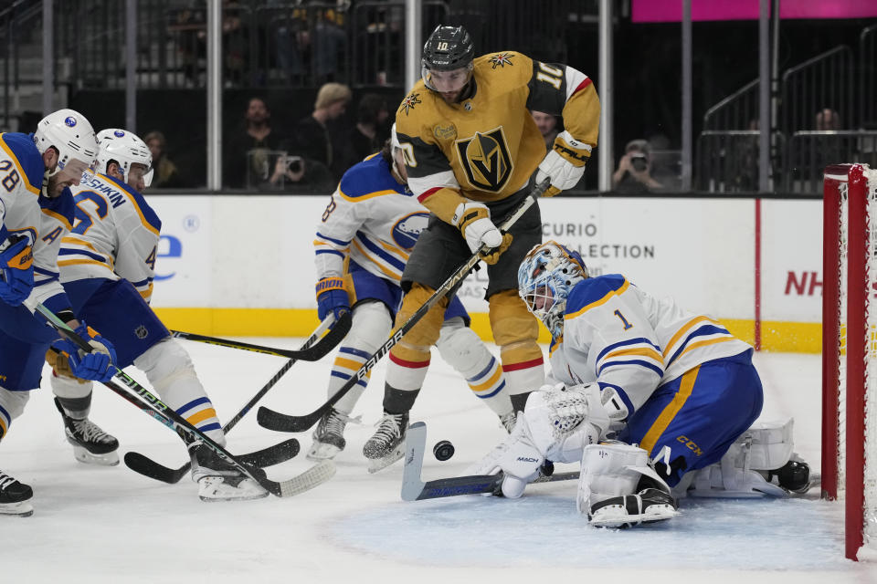 Vegas Golden Knights center Nicolas Roy (10) shoots on Buffalo Sabres goaltender Ukko-Pekka Luukkonen (1) during the second period of an NHL hockey game Monday, Dec. 19, 2022, in Las Vegas. (AP Photo/John Locher)