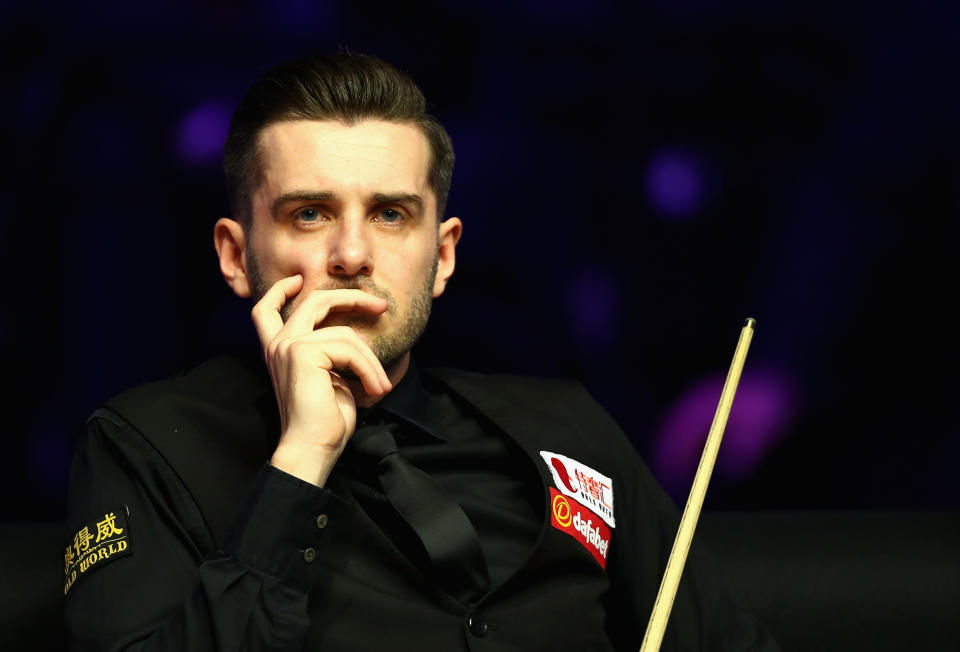 Joe Perry stunned defending champion Mark Selby to progress to the second round of the World Snooker Championship.