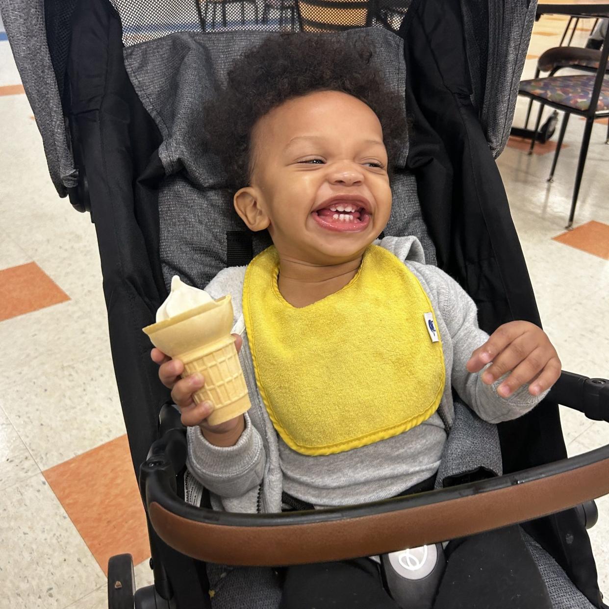 Makaela King's son Dakari is tickled to death with the ice cream cone he got while with his mom at Virginia State University's Gateway Dining Hall. Makaela King is one of six students living with their children at the University Apartments at Ettrick. VSU opened the apartments in November as part of the $1.45 million grant it received from the U.S. Department of Education's Child Care Access Means Parents In School [CCAMPIS] program.