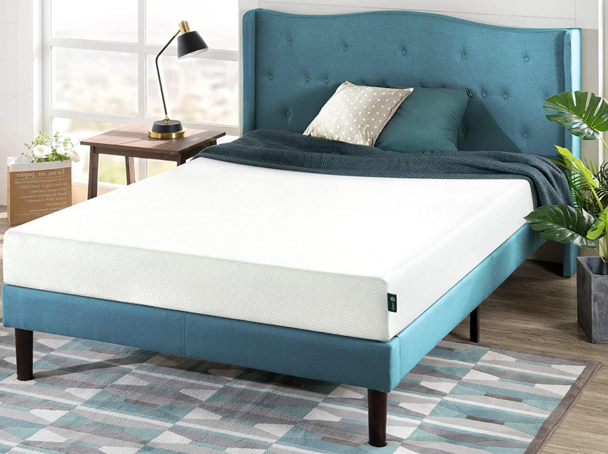 White mattress on a blue bed