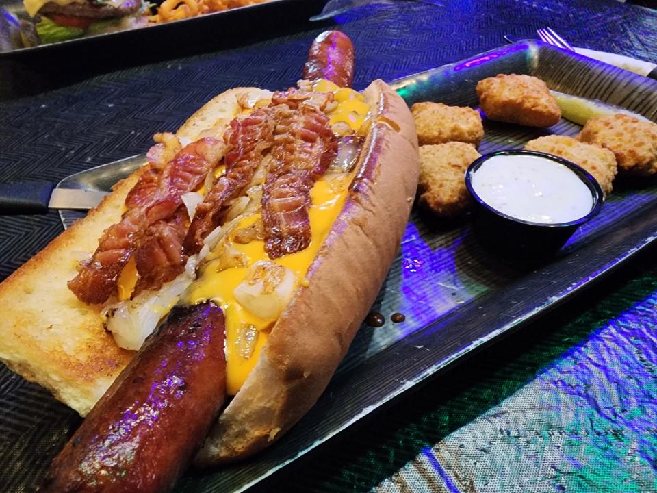 The Junkyard Dog, which is a footlong hotdog smothered in bacon, chili, nacho cheese and sauteed onions.