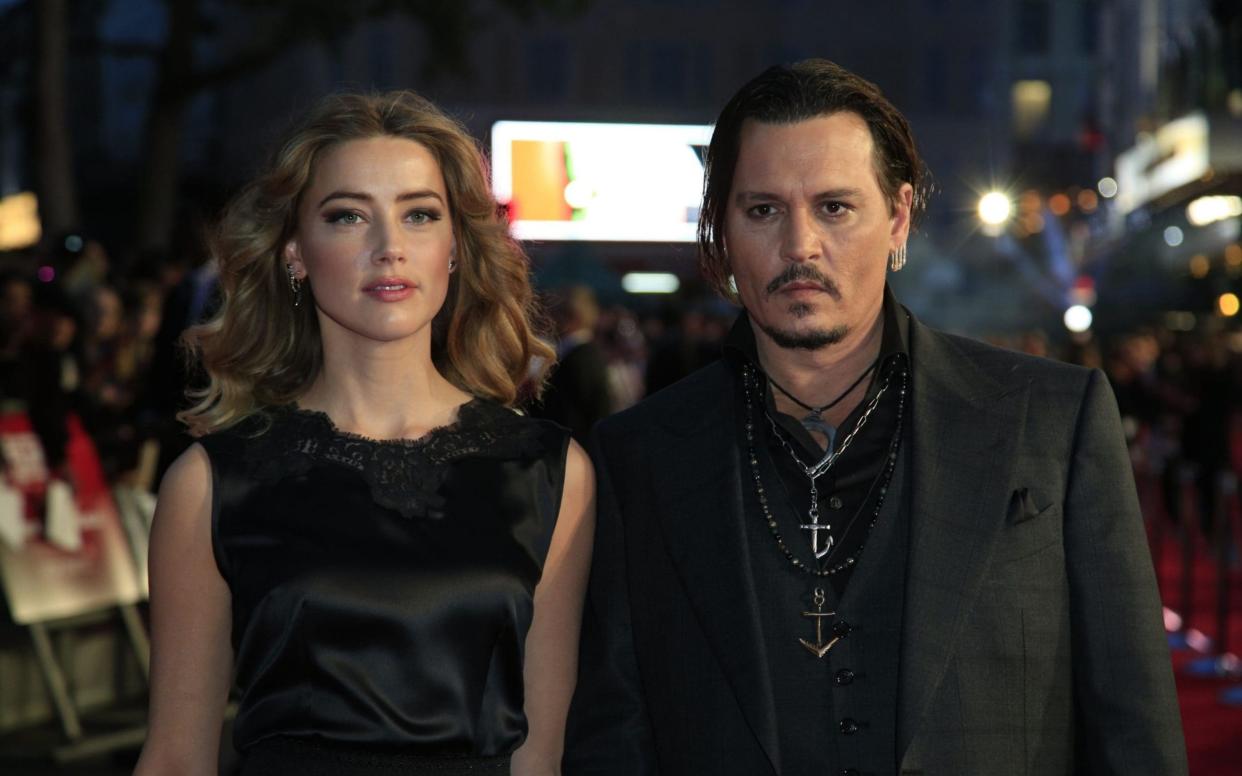 Amber Heard and Johnny Depp early in their marriage in 2015 - PA