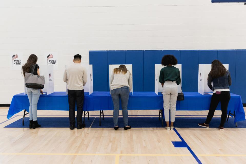 Voters fill out their ballots.