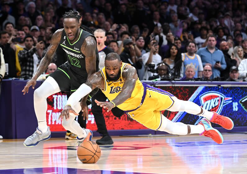 Los Angeles, California April 11, 2023-Lakers LeBron James dives for the ball in front of Timberwolves Taurean Prince after turning the ball over in the fourth quarter during a play-in game four the NBA playoffs at Crypto.com arena Tuesday. (Wally Skalij/Los Angeles Times)