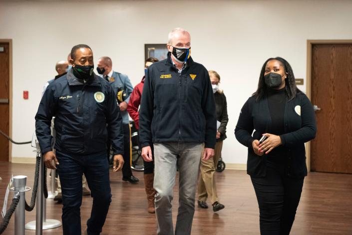 Dec. 31, 2021; EAST ORANGE, NJ, USA; (center) Governor Phil Murphy tours a new federal COVID-19 testing site at the East Orange Division of Senior Services at 90 Halsted Street. (Right) Monique Griffith, East Orange Director of Health and Human Services, leads the tour. (Left) East Orange Mayor Ted Green.Mandatory Credit: Michael Karas/NorthJersey.com via USA TODAY NETWORK