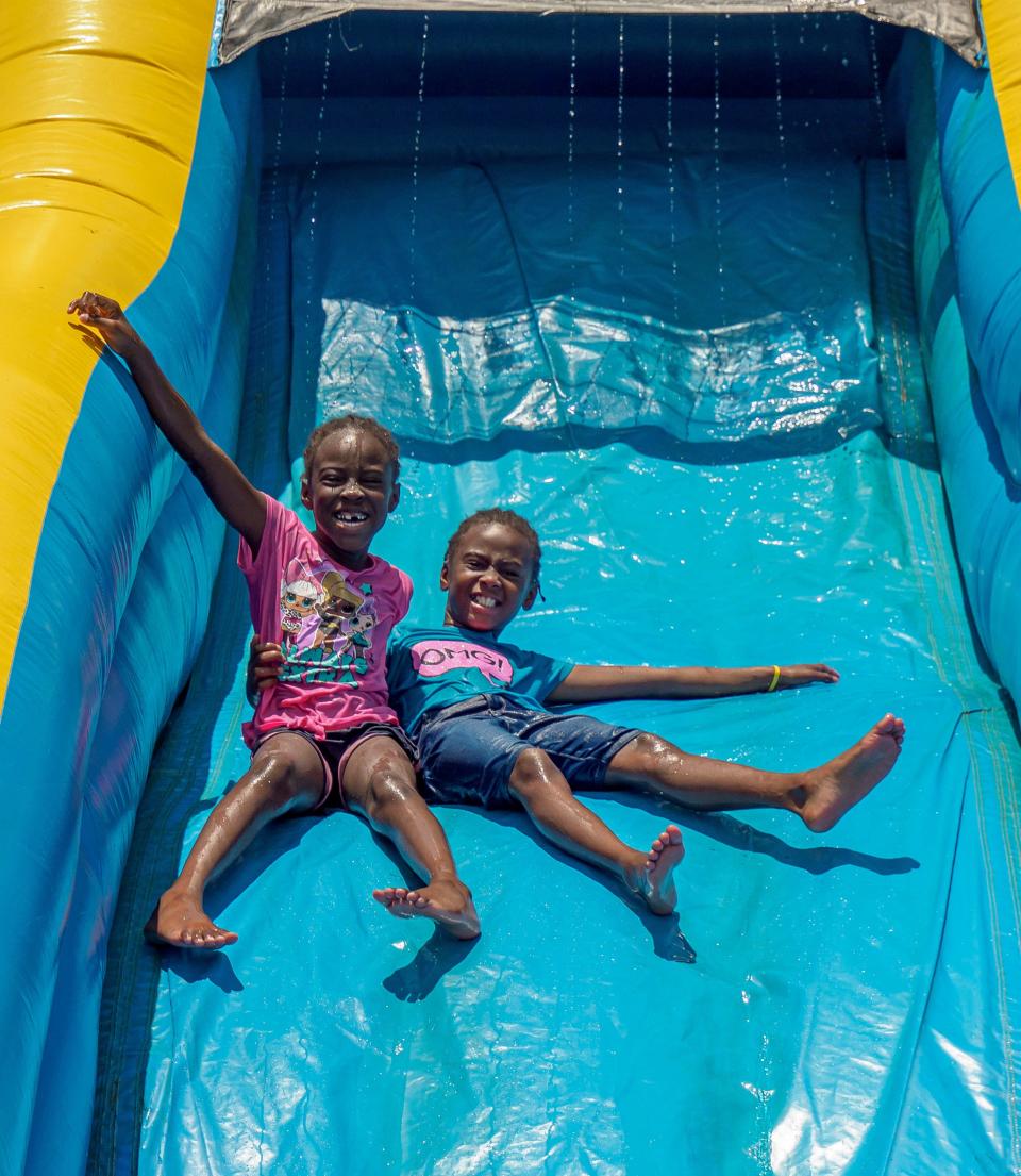 Children slip down a water slide at a Juneteenth celebration at Cauley Lott Park in Mount Dora, Florida, on June 18, 2022.