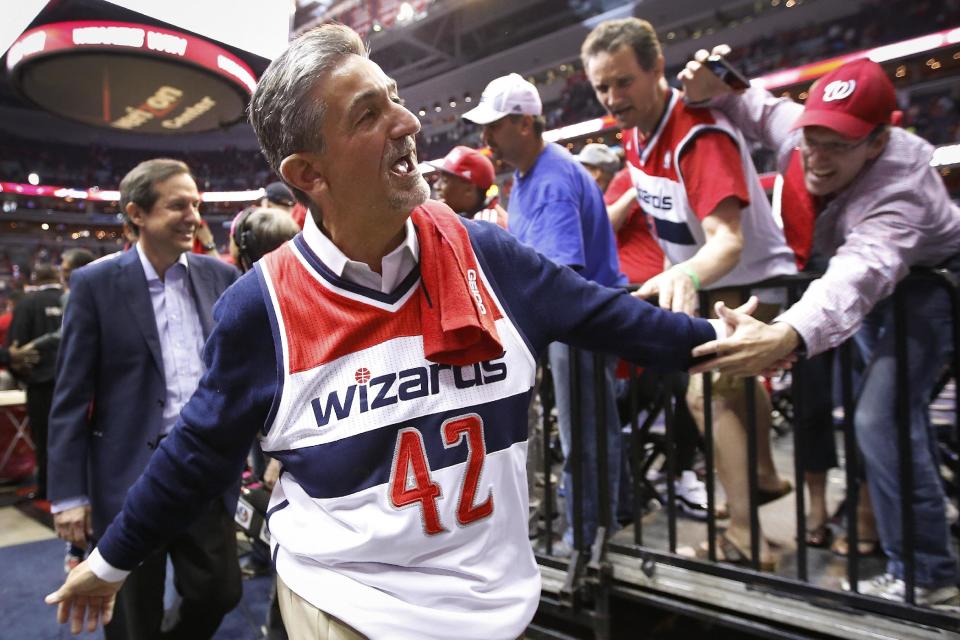 Wearing a Nene jersey, Washington Wizards owner Ted Leonsis walks off the floor after Game 4 of an opening-round NBA basketball playoff series against the Chicago Bulls in Washington, Sunday, April 27, 2014. The Wizards defeated the Bulls 98-89. Wizards forward Nene was suspended for an altercation in Game 3. (AP Photo/Alex Brandon)