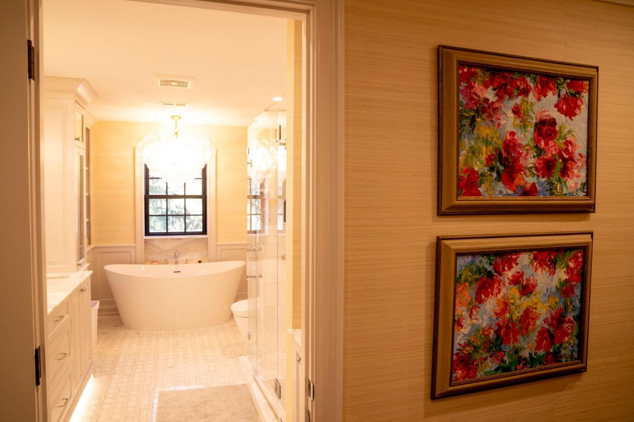 This bathroom is lined with grass cloth wallpaper.