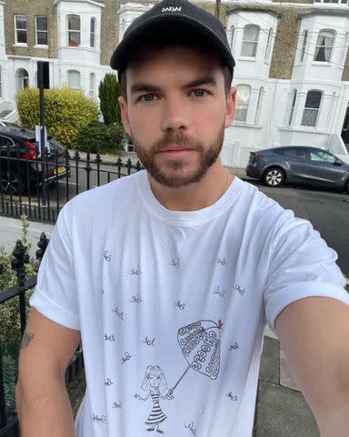 <p>Nicola Coughlan Instagram</p> Luke Newton takes a selfie in a T-shirt Nicola Coughlan designed.