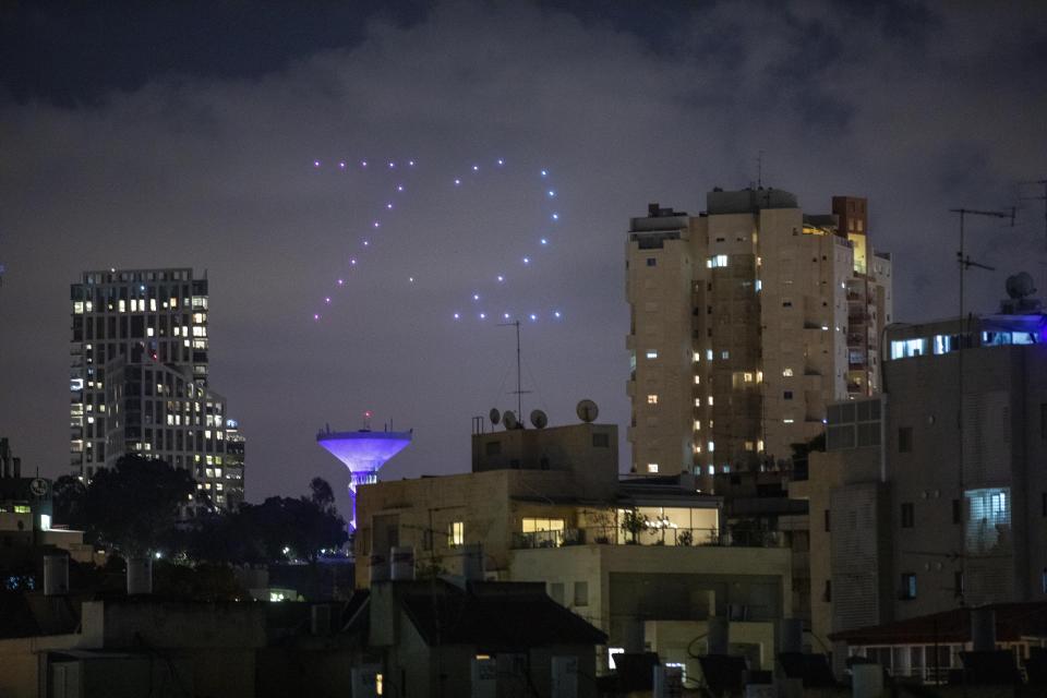 Drones form number 72 during celebrations for Israel's 72nd Independence Day, in Ramat Gan, Israel, Tuesday, April 28, 2020. Israel government announced a complete lockdown over the upcoming Israel's 72nd Independence Day to control the country's coronavirus outbreak. (AP Photo/Oded Balilty)