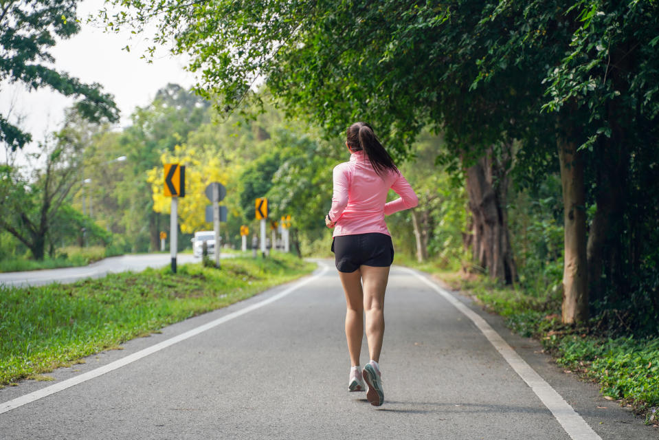 Healthy woman jogging run and workout on road outdoor. Asian runner people exercise gym with fitness session, nature park background. Health and Lifestyle Concept