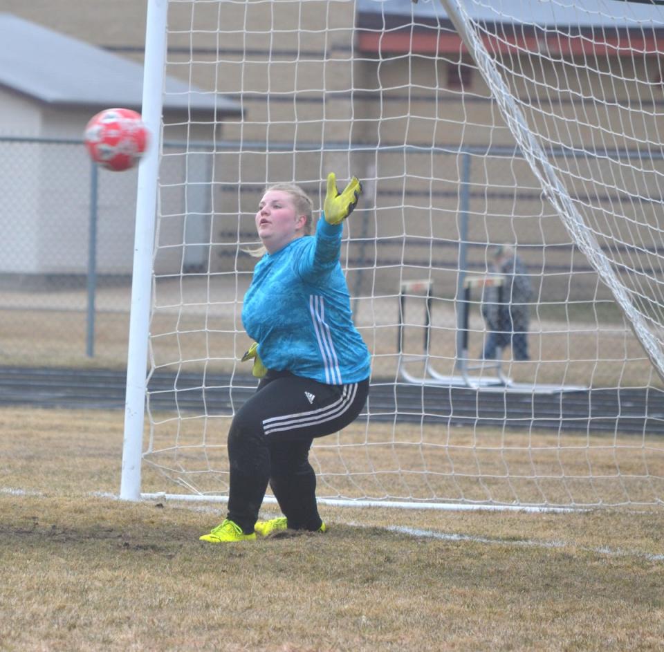 Cheboygan junior goalkeeper Callie Wanke reaches out to stop an Alpena penalty kick attempt in the first half Wednesday.