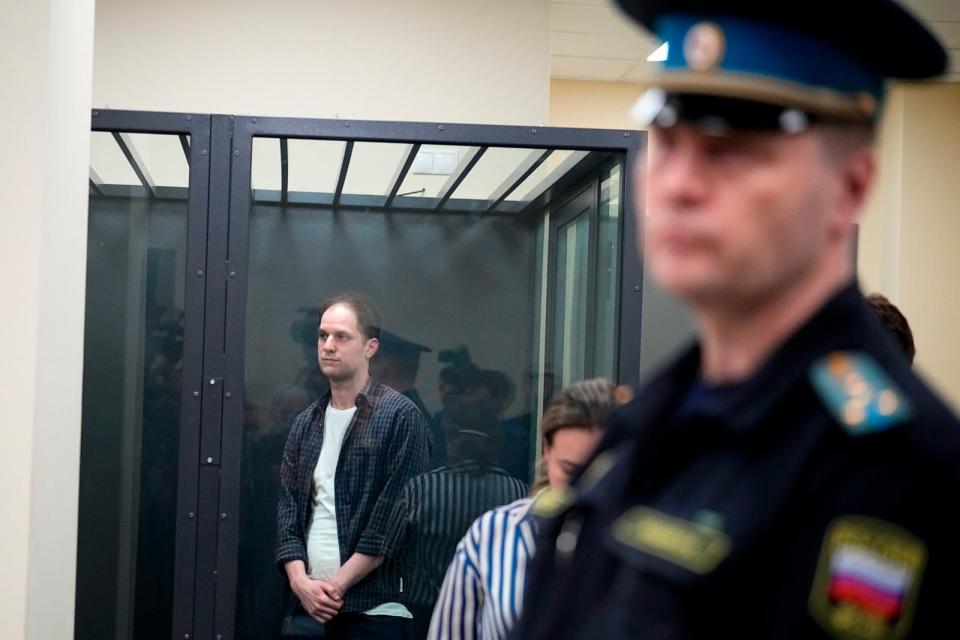 PHOTO: Wall Street Journal reporter Evan Gershkovich, left, stands in a glass cage in a courtroom at the First Appeals Court of General Jurisdiction in Moscow, Russia, Tuesday, April 23, 2024. (Alexander Zemlianichenko/AP, FILE)